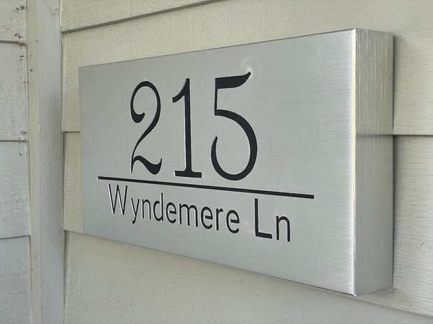 An illuminated Aluminum house sign that looks great during the day but truly shines at night with 46 LEDs and a dawn to dusk sensor -Brushed Aluminum